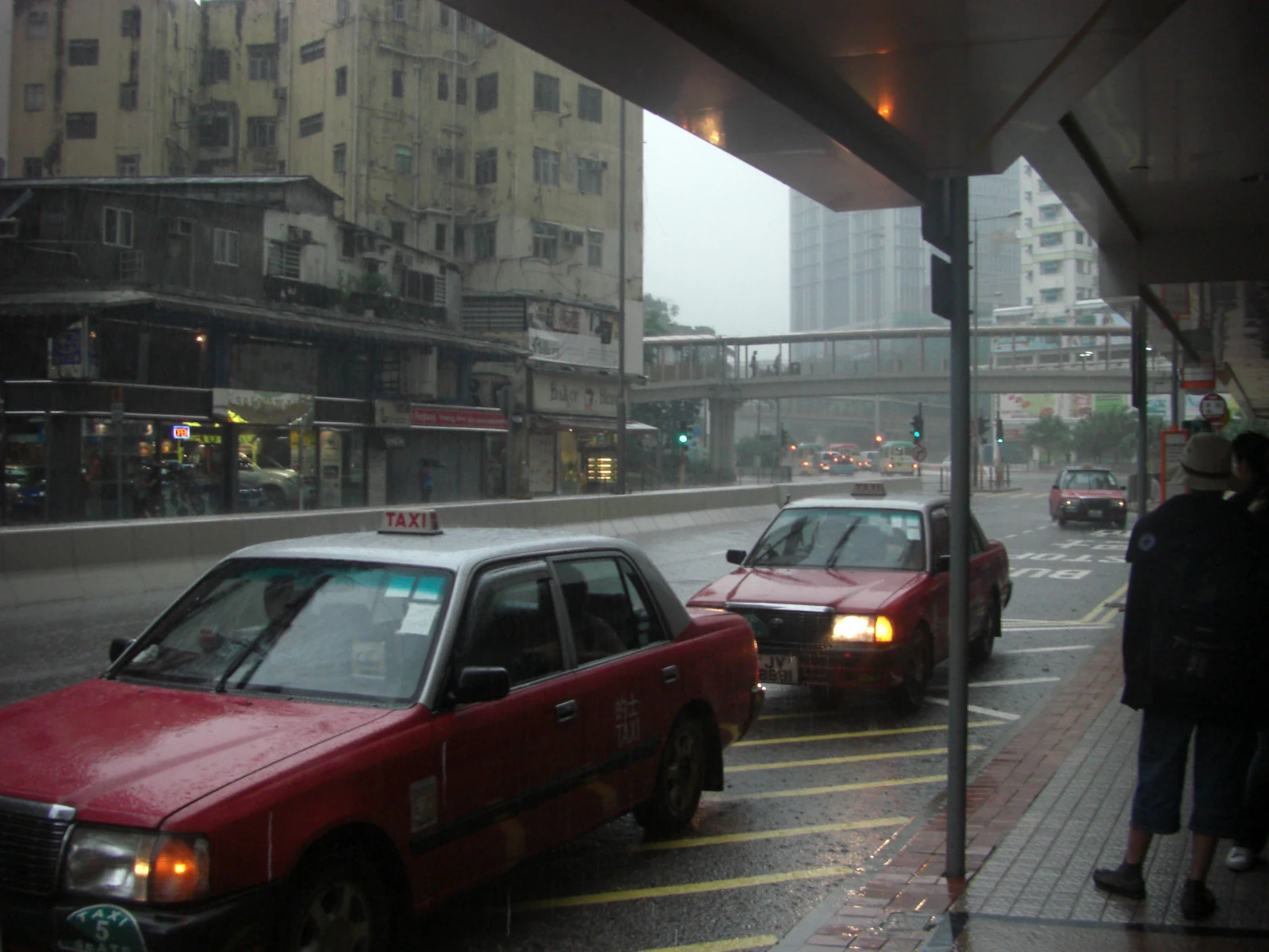 Taxis and a wet roadway on Kwan Mun Hau Street in Tsuen Wan