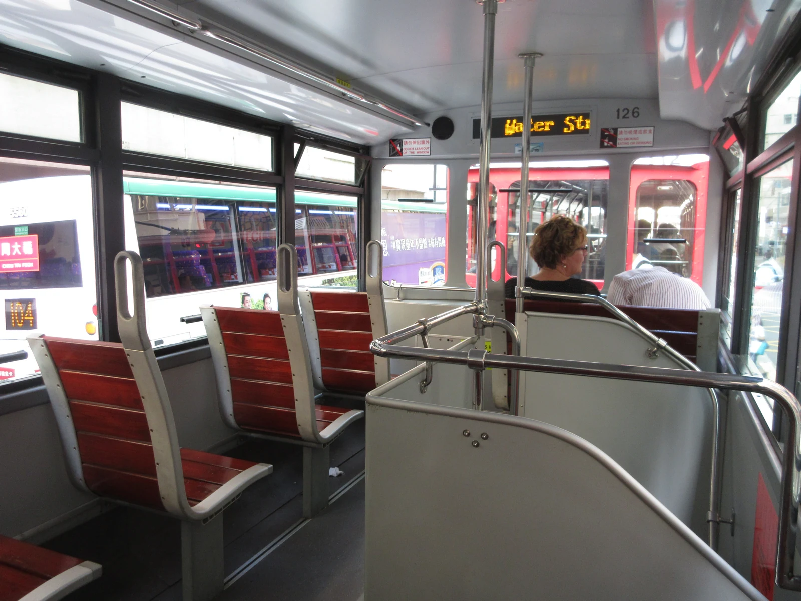 Upper-deck tram seats and a narrow aisle