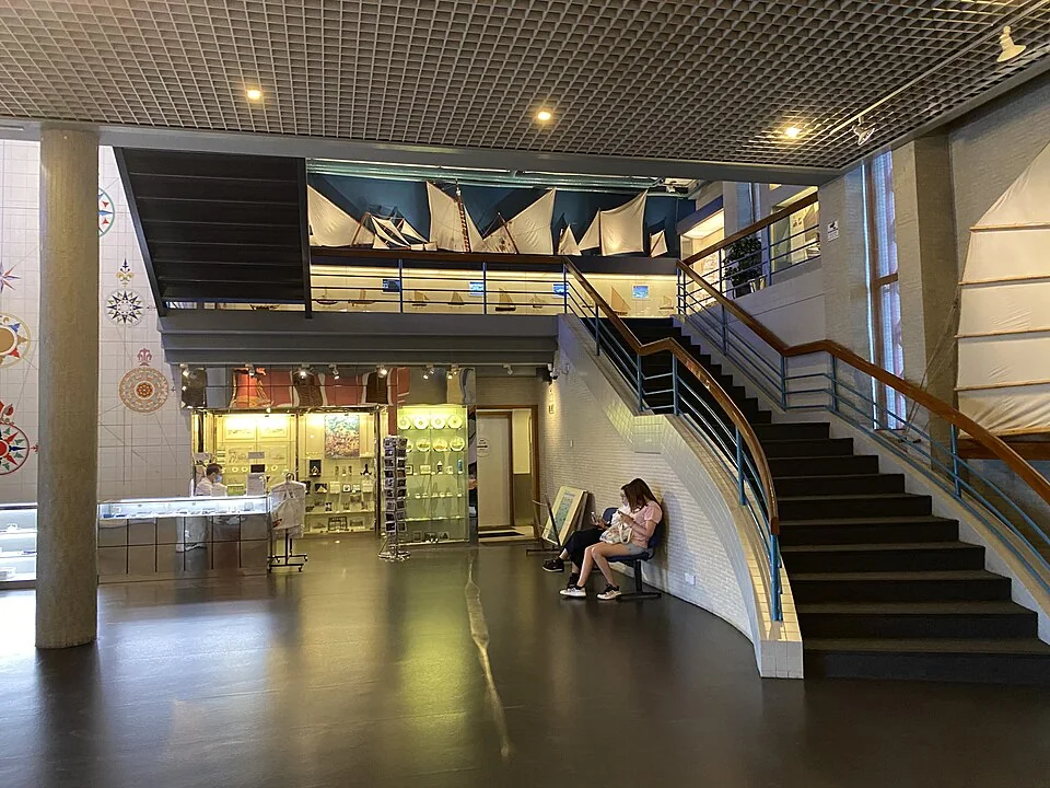 Lobby stairs and model sails visible on an upper level of Macau Maritime Museum